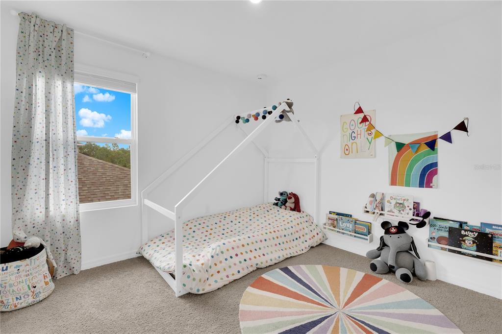 4226 Southern Vista Loop St. Cloud, FL 34772 - Photo 18 of 39 a bedroom with furniture and a window