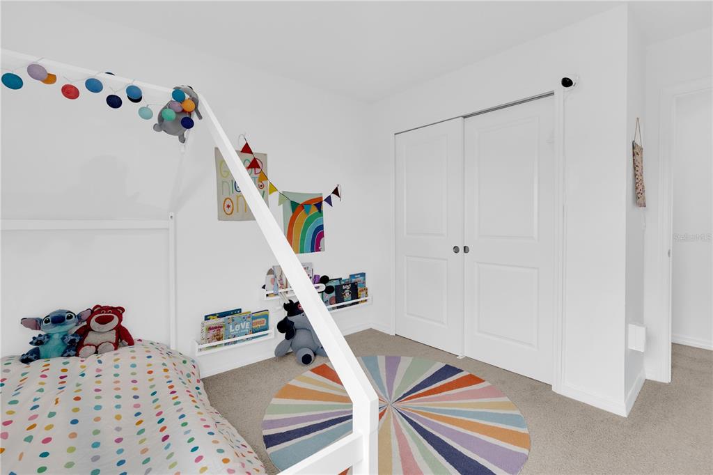 4226 Southern Vista Loop St. Cloud, FL 34772 - Photo 19 of 39 a bedroom with a bed and wooden floor