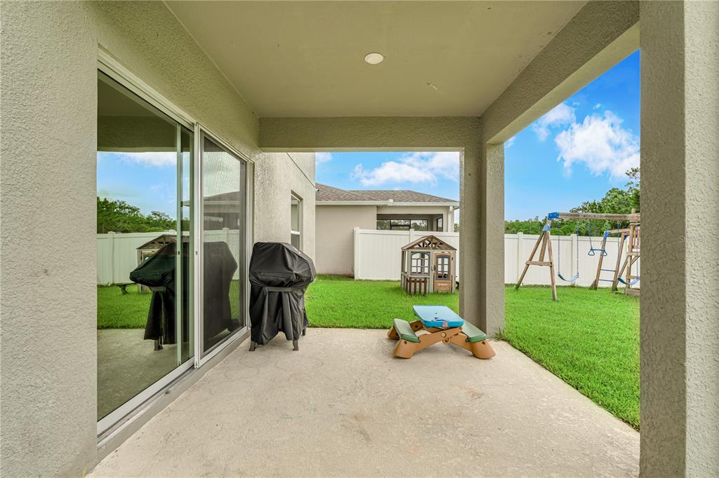 4226 Southern Vista Loop St. Cloud, FL 34772 - Photo 29 of 39 a front view of a house with garden