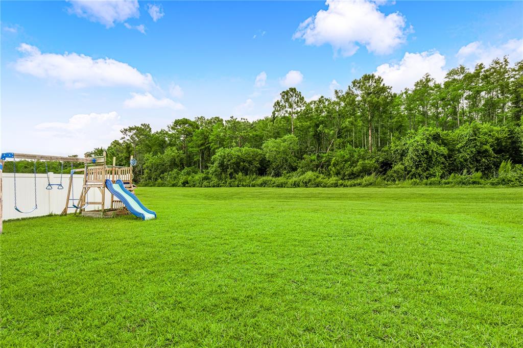 4226 Southern Vista Loop St. Cloud, FL 34772 - Photo 30 of 39 a view of yard with swimming pool and green space