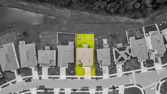 an aerial view of residential houses with outdoor space and street view