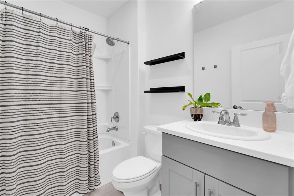 4226 Southern Vista Loop St. Cloud, FL 34772 - Photo 6 of 39 a bathroom with a sink a toilet and shower