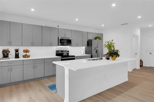 a kitchen with a sink a stove and refrigerator