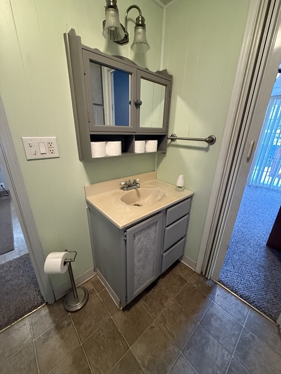 4 Center Street Brimfield, MA 01010 - Photo 12 of 16 a bathroom with a sink a mirror and toilet