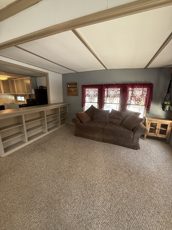 4 Center Street Brimfield, MA 01010 - Photo 7 of 16 a living room with furniture a flat screen tv and a large window