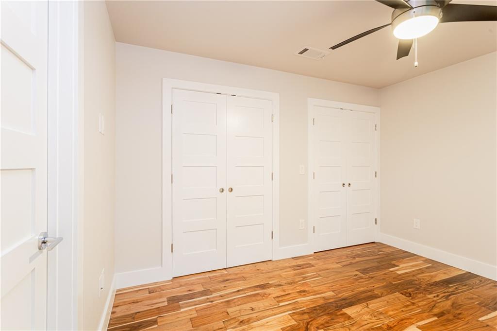 2509 Del Curto Road, Unit B Austin, TX 78704 - Photo 16 of 31 Unfurnished bedroom with ceiling fan, baseboards, visible vents, and light wood-style floors