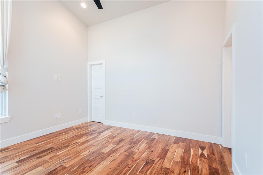 2509 Del Curto Road, Unit B Austin, TX 78704 - Photo 19 of 31 Unfurnished room with light wood-style floors, baseboards, lofted ceiling, and recessed lighting