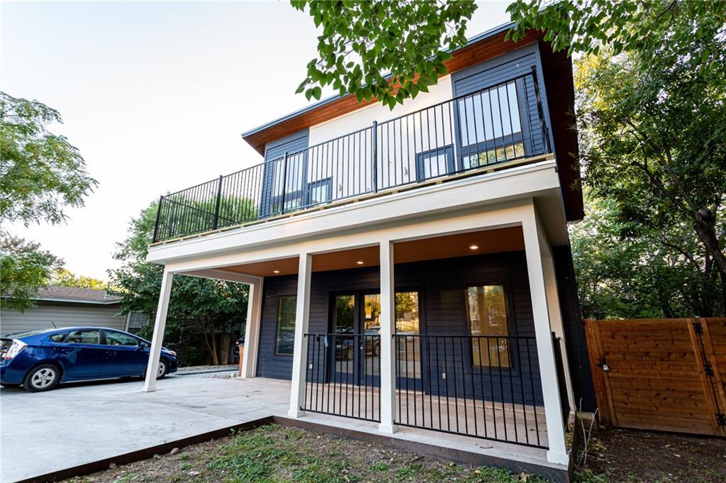 2509 Del Curto Road, Unit B Austin, TX 78704 - Photo 2 of 31 Back of house featuring concrete driveway, fence, and a balcony