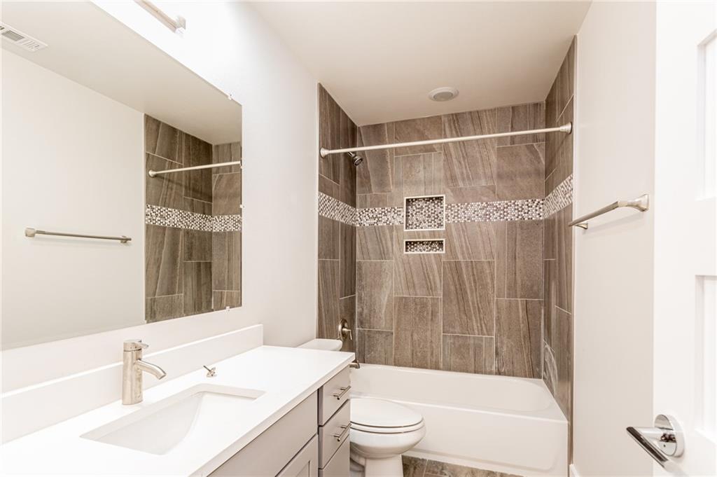 2509 Del Curto Road, Unit B Austin, TX 78704 - Photo 23 of 31 Full bath with bathing tub / shower combination, toilet, visible vents, and vanity
