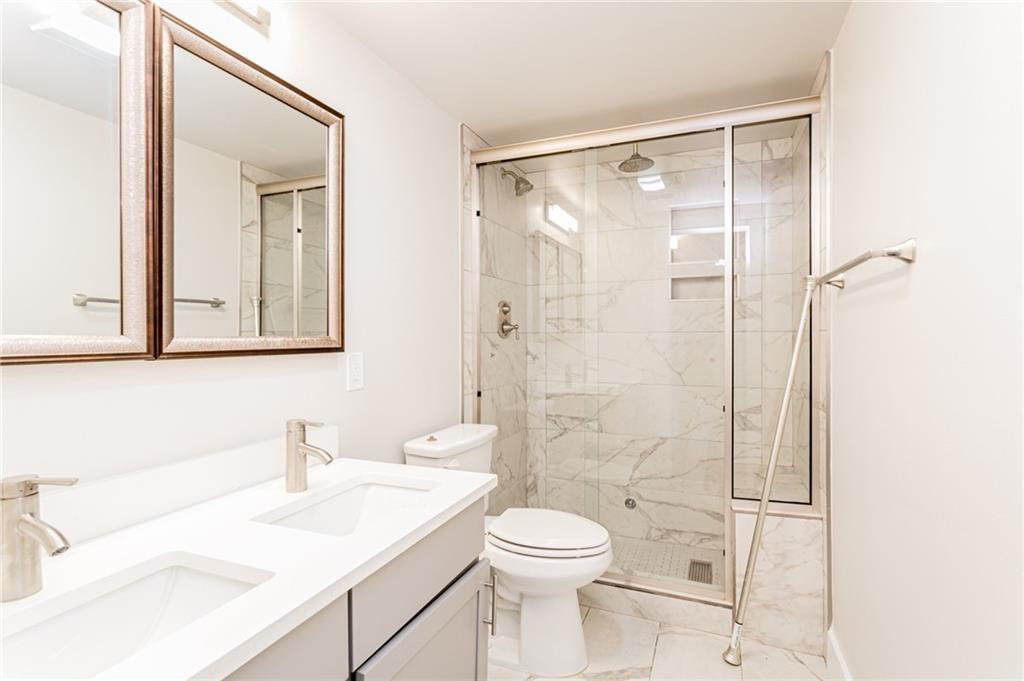 2509 Del Curto Road, Unit B Austin, TX 78704 - Photo 25 of 31 Full bathroom featuring a marble finish shower, marble finish floor, toilet, and a sink