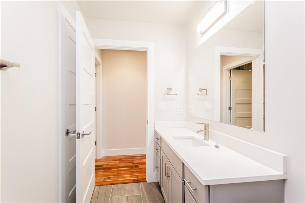 2509 Del Curto Road, Unit B Austin, TX 78704 - Photo 27 of 31 Bathroom featuring baseboards, vanity, and wood finished floors