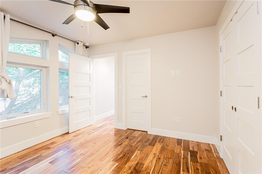 2509 Del Curto Road, Unit B Austin, TX 78704 - Photo 4 of 31 Unfurnished bedroom featuring wood finished floors, baseboards, and ceiling fan