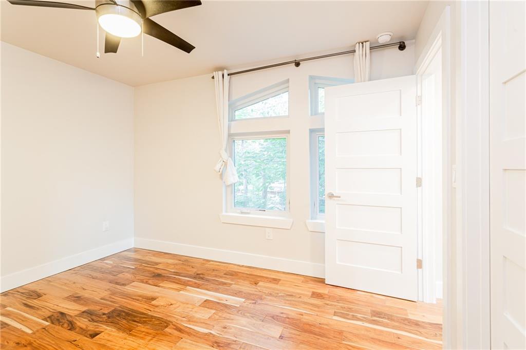 2509 Del Curto Road, Unit B Austin, TX 78704 - Photo 5 of 31 Empty room with a ceiling fan, baseboards, a healthy amount of sunlight, and light wood-style flooring