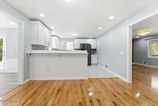 a kitchen with a refrigerator sink and cabinets