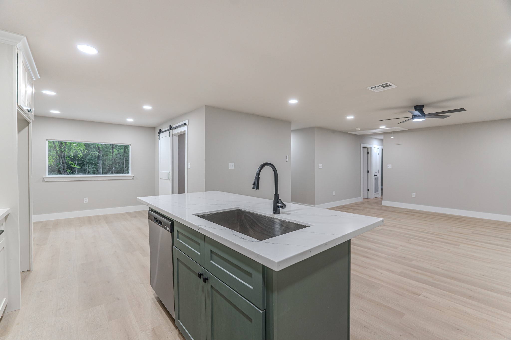 26701 Knottywood Oakhurst, TX 77359 - Photo 19 of 47 a view of kitchen island a sink wooden floor and entryway