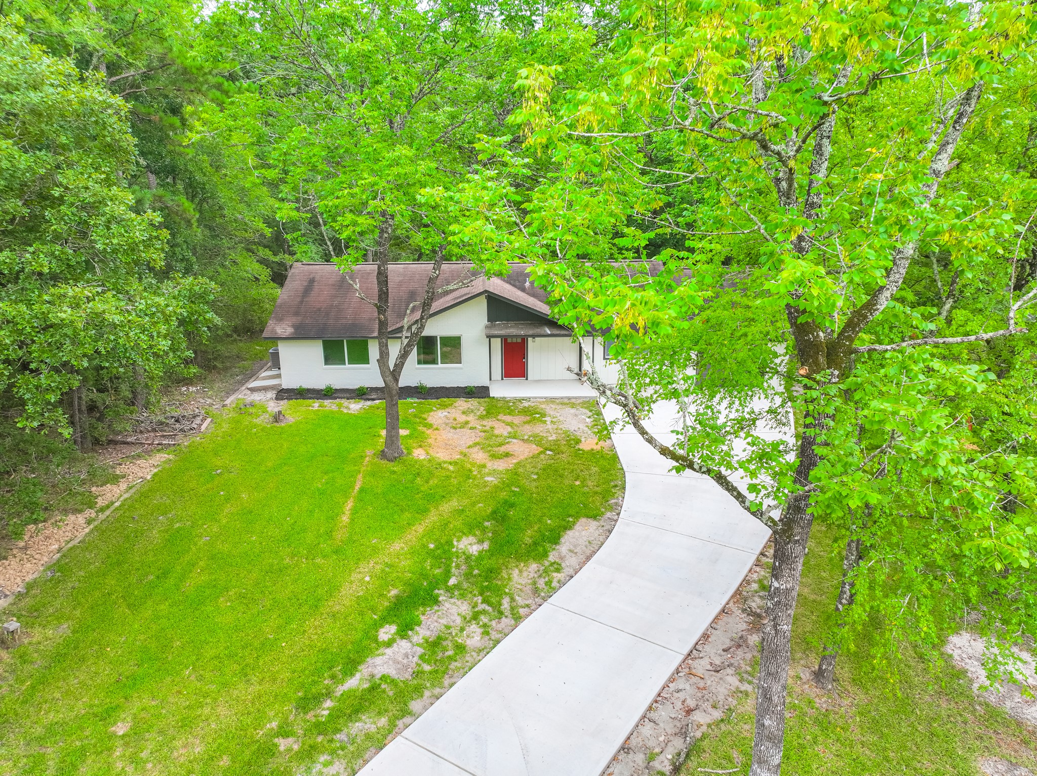 26701 Knottywood Oakhurst, TX 77359 - Photo 3 of 47 a view of a house with a backyard