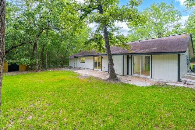a view of a house with a yard and a patio