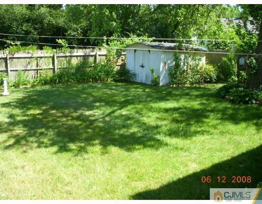 51 Helmetta Road Monroe Township, NJ 08831 - Photo 4 of 8 a backyard of a house with lots of green space and lake view
