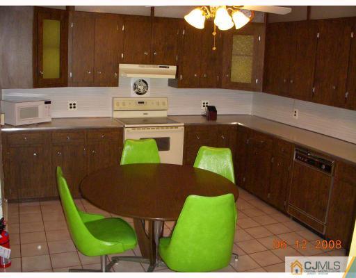 51 Helmetta Road Monroe Township, NJ 08831 - Photo 6 of 8 a kitchen with a sink cabinets and a wooden floor