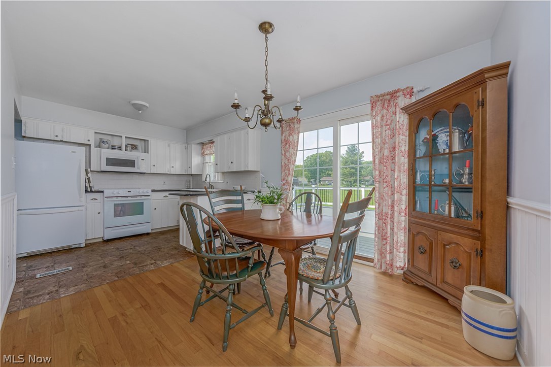 3331 Boyne Road Barberton, OH 44203 - Photo 5 of 22 The dining area next to the kitchen features hardwood floors and access to the backyard.