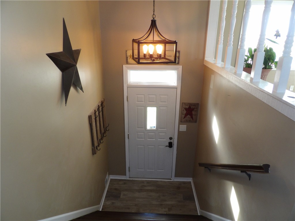 4505 North Alcony Conover Road Conover, OH 45317 - Photo 60 of 64 This inviting entrance features rich wood flooring, a clear paneled door, and elegant balusters.
