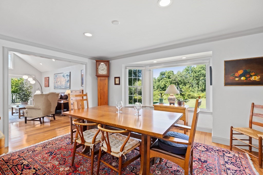 82 Thistle Patch Way, Unit 82 Hingham, MA 02043 - Photo 14 of 39 a dining room with furniture and wooden floor to ceiling windows