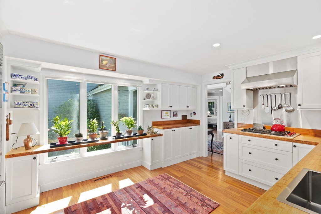 82 Thistle Patch Way, Unit 82 Hingham, MA 02043 - Photo 15 of 39 a large white kitchen with a large window and stove