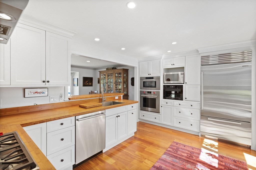 82 Thistle Patch Way, Unit 82 Hingham, MA 02043 - Photo 17 of 39 a large kitchen with lot of counter space and wooden floor