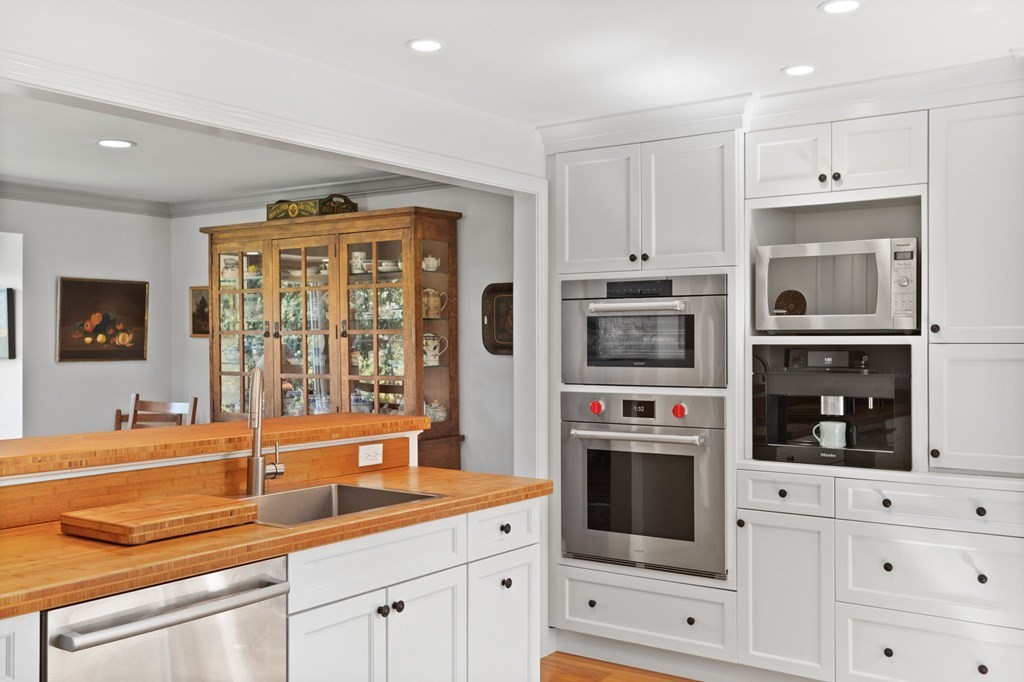 82 Thistle Patch Way, Unit 82 Hingham, MA 02043 - Photo 18 of 39 a kitchen with stainless steel appliances granite countertop a stove and white cabinets