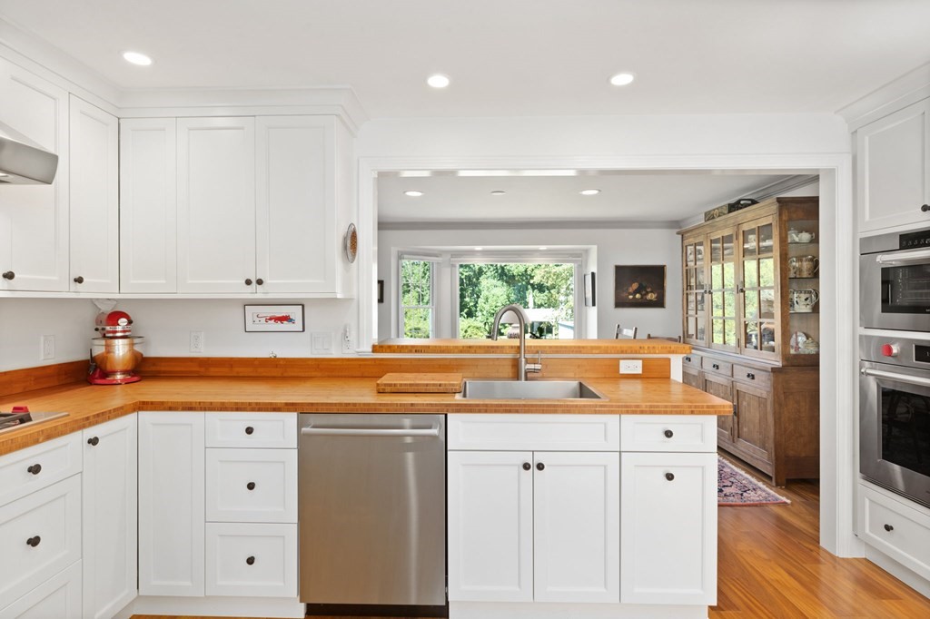 82 Thistle Patch Way, Unit 82 Hingham, MA 02043 - Photo 19 of 39 a kitchen with white cabinets and sink