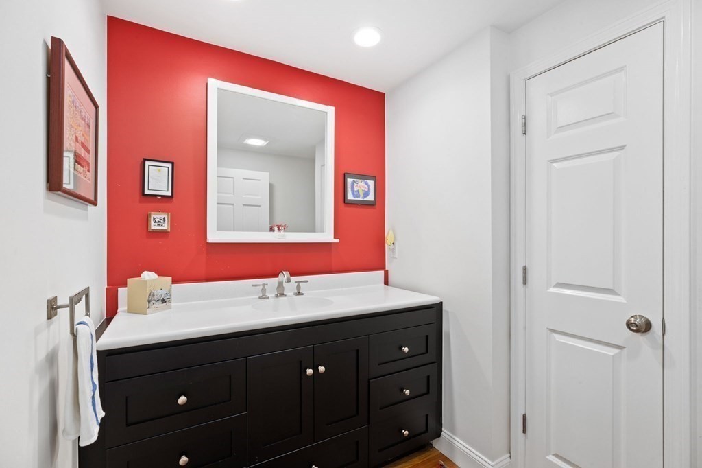 82 Thistle Patch Way, Unit 82 Hingham, MA 02043 - Photo 20 of 39 a bathroom with a sink vanity and a mirror
