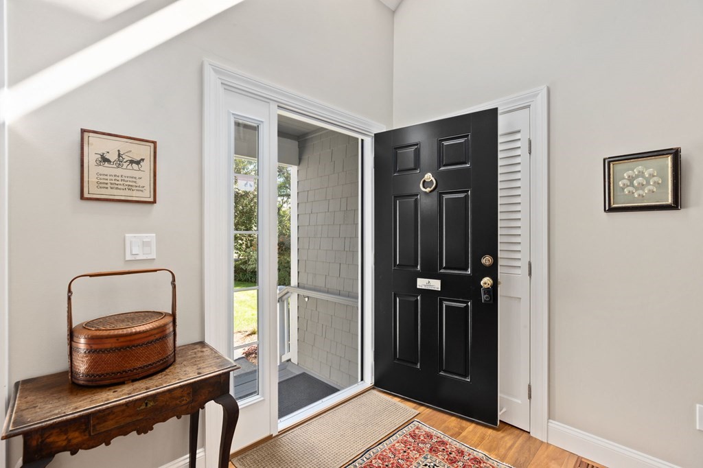 82 Thistle Patch Way, Unit 82 Hingham, MA 02043 - Photo 2 of 39 a room with a refrigerator and wooden floor