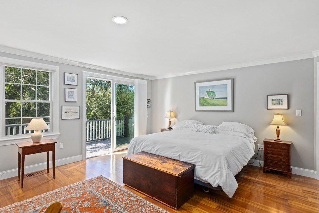 82 Thistle Patch Way, Unit 82 Hingham, MA 02043 - Photo 23 of 39 a bedroom with a bed and wooden floor