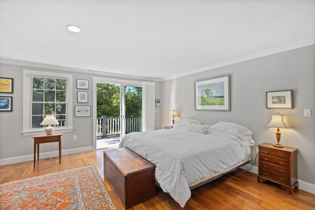 82 Thistle Patch Way, Unit 82 Hingham, MA 02043 - Photo 24 of 39 a bedroom with a bed and wooden floor