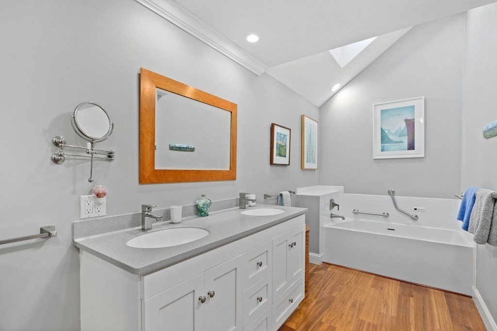 82 Thistle Patch Way, Unit 82 Hingham, MA 02043 - Photo 26 of 39 a bathroom with a sink double vanity and a mirror