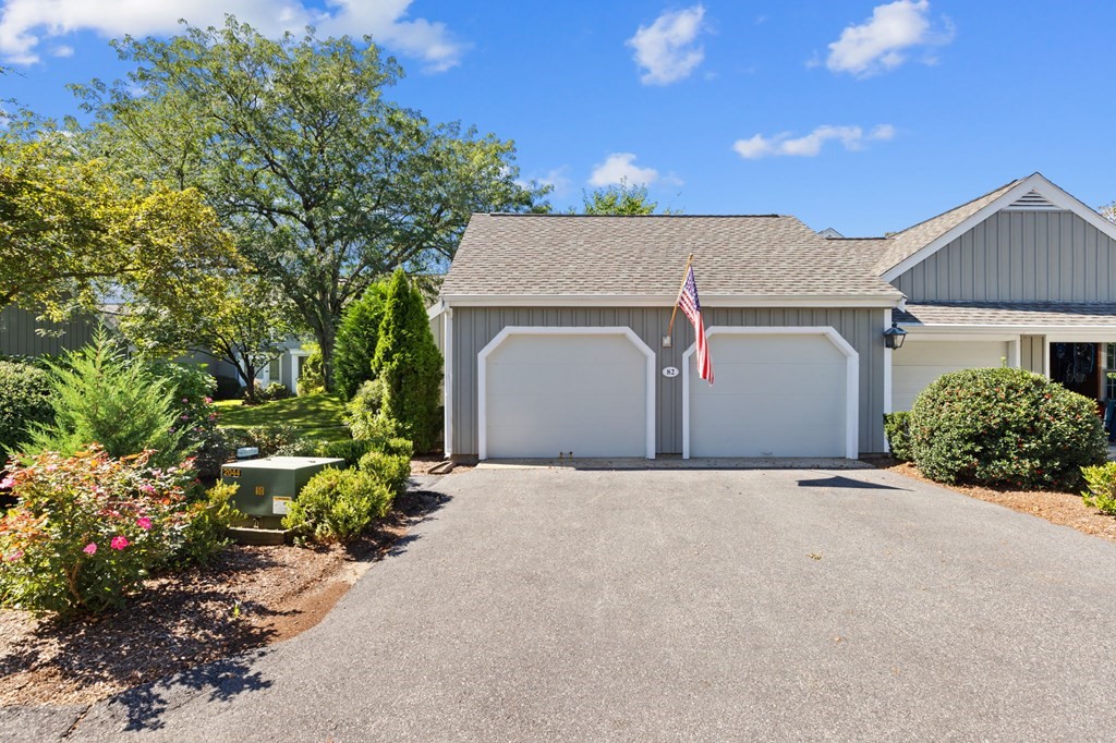 82 Thistle Patch Way, Unit 82 Hingham, MA 02043 - Photo 38 of 39 a front view of a house with a yard and garage