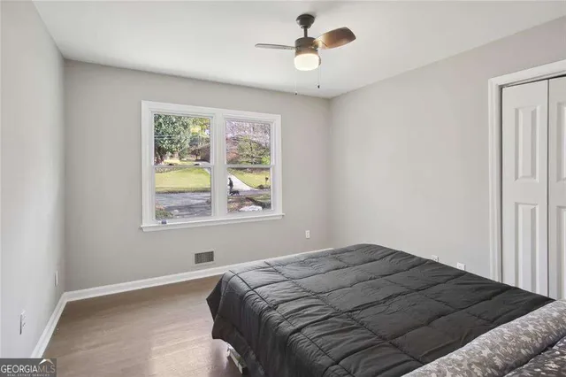 a bedroom with a bed and a window