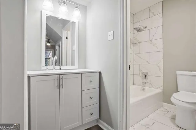 a bathroom with a bathtub a sink a toilet and a mirror