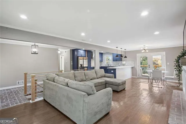 a living room with furniture and view of kitchen
