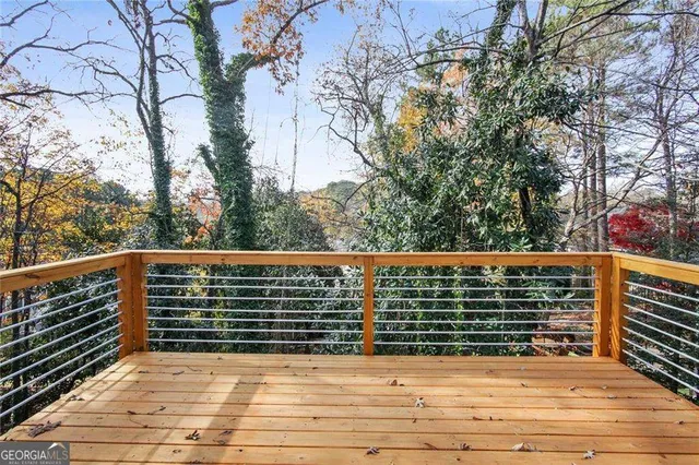 a view of balcony with wooden floor and fence
