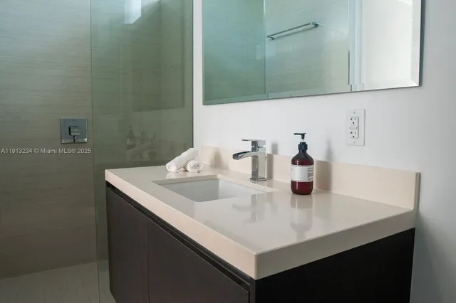 a bedroom with furniture and a view of living room