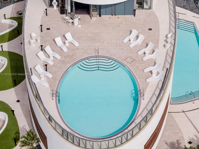 an aerial view of a house with a swimming pool