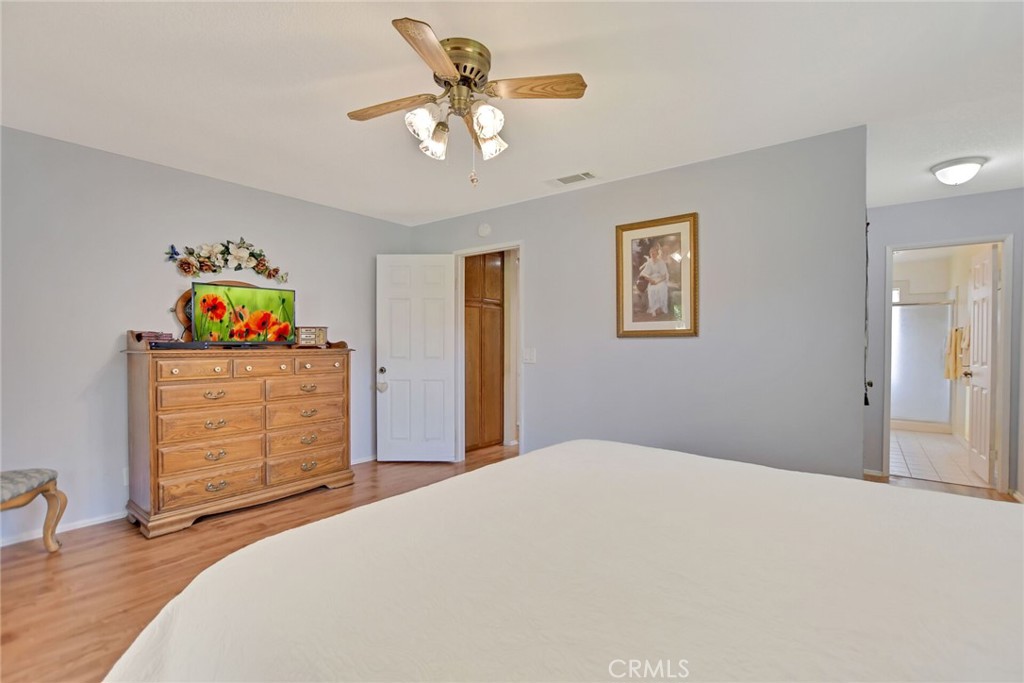 1300 Cherry Drive Hemet, CA 92545 - Photo 20 of 32 a bedroom with a bed and a chandelier