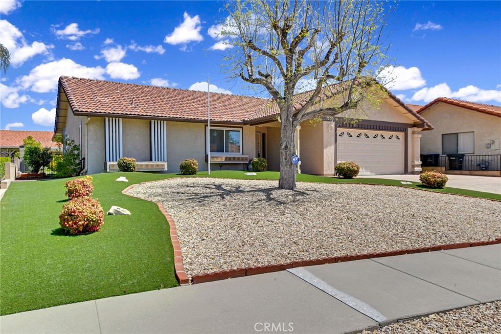 1300 Cherry Drive Hemet, CA 92545 - Photo 3 of 32 a front view of a house with a yard and porch