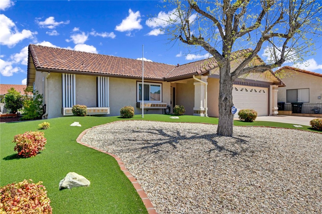 1300 Cherry Drive Hemet, CA 92545 - Photo 4 of 32 a front view of a house with a yard and garage