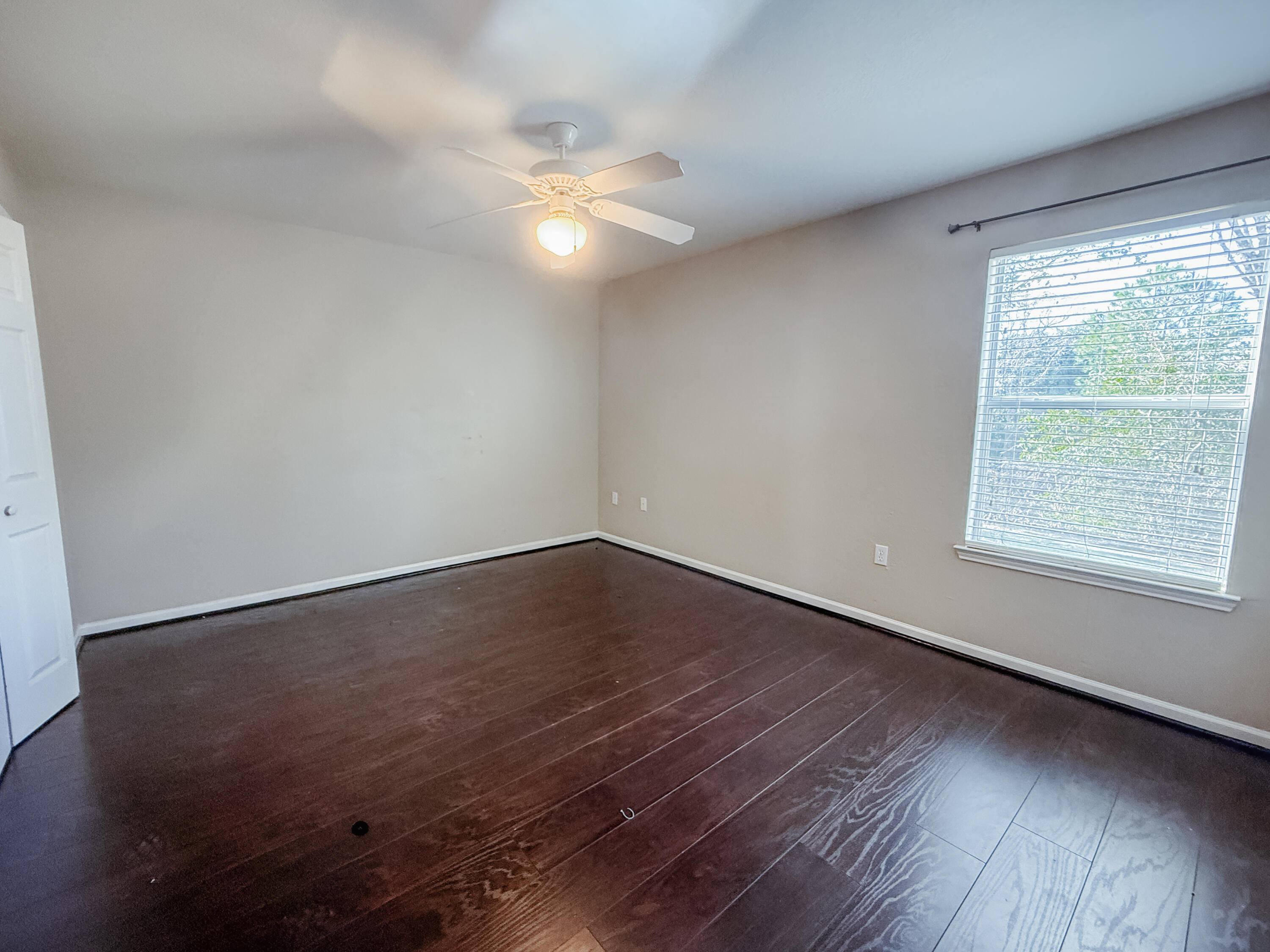 1150 Airport Road, Unit 110 Destin, FL 32541 - Photo 11 of 20 an empty room with wooden floor and windows