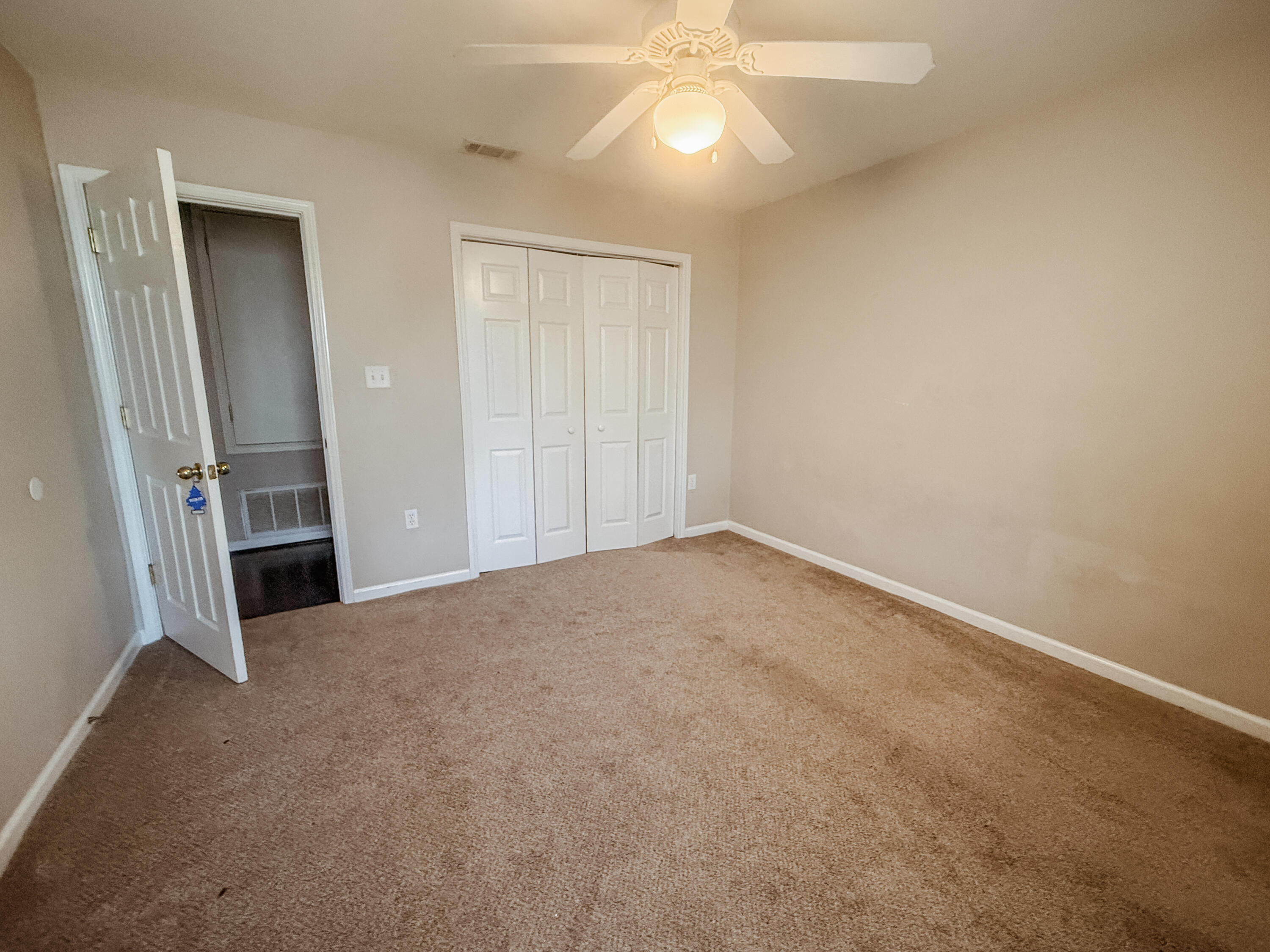 1150 Airport Road, Unit 110 Destin, FL 32541 - Photo 15 of 20 an empty room with closet and mirror