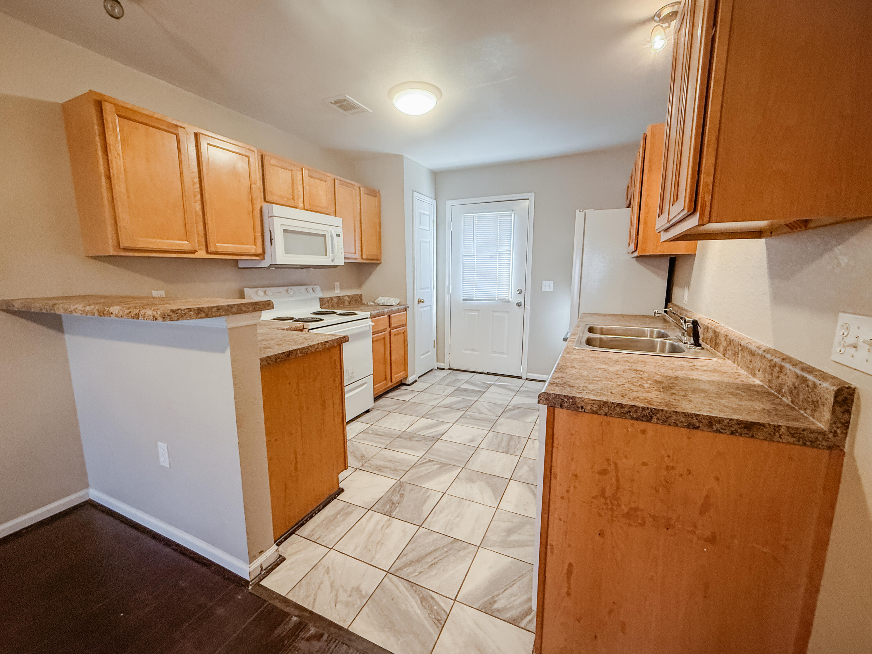1150 Airport Road, Unit 110 Destin, FL 32541 - Photo 3 of 20 a kitchen with stainless steel appliances granite countertop a sink stove and cabinets