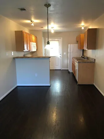 a view of a kitchen with kitchen appliances and a sink