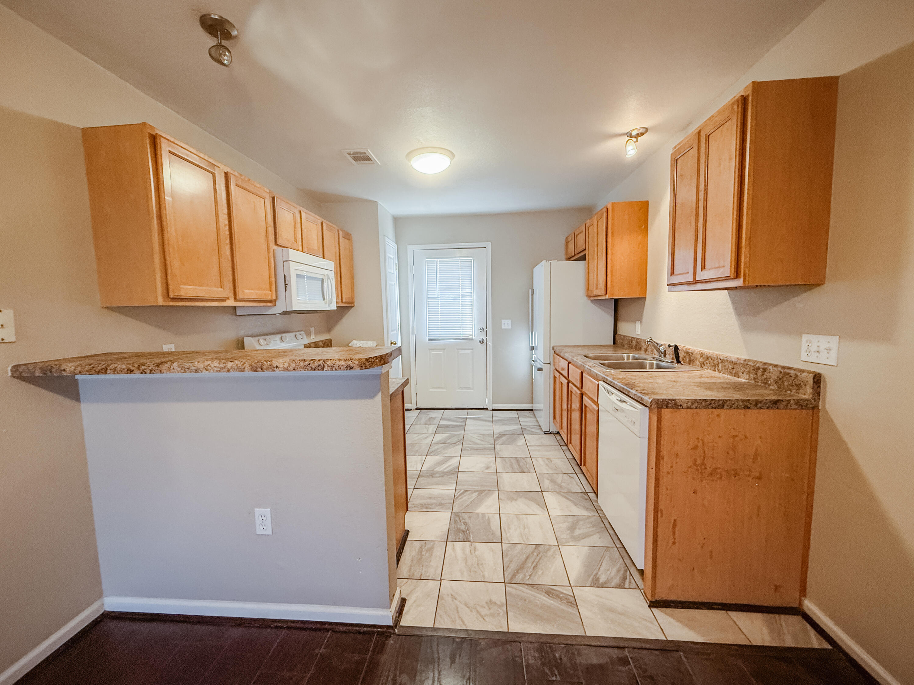 1150 Airport Road, Unit 110 Destin, FL 32541 - Photo 4 of 20 a kitchen with stainless steel appliances granite countertop a stove a sink and a refrigerator